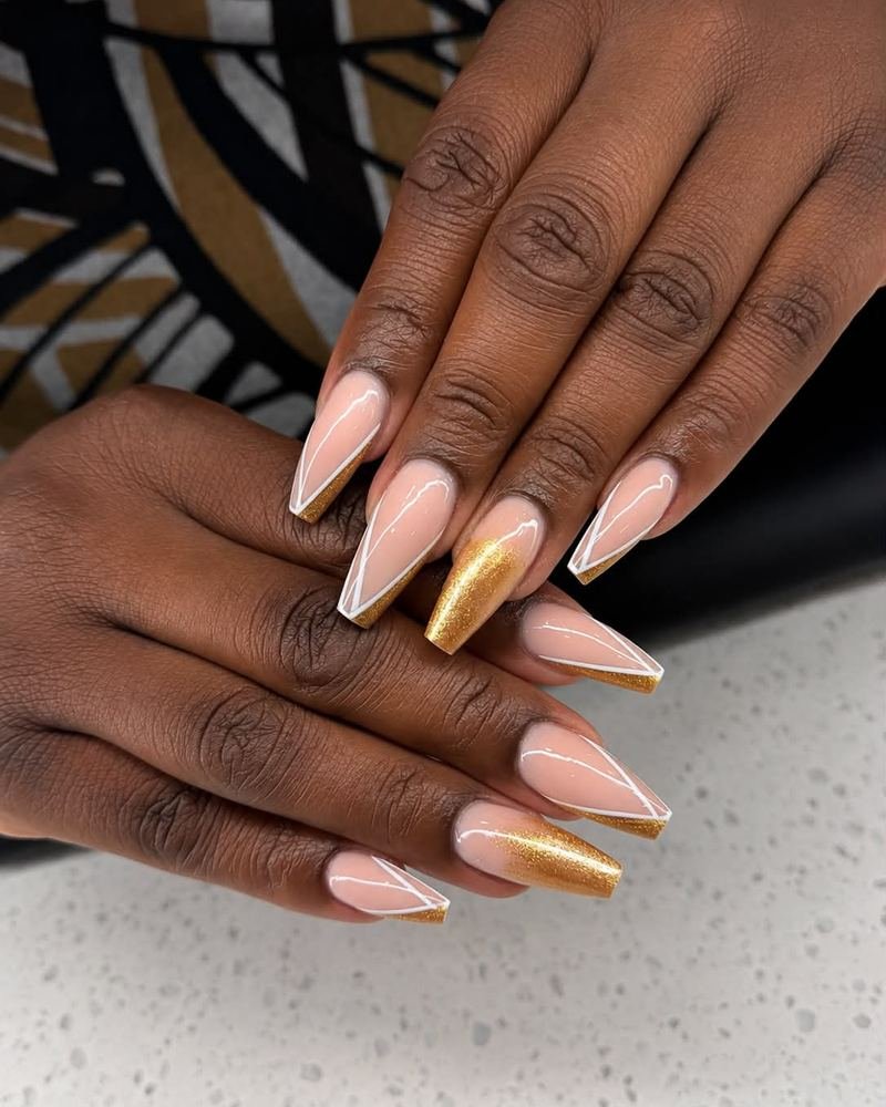 Nude stiletto set with gold chrome tips, made at Top Nails
